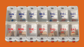 am pm pillbox containing pills in each slot