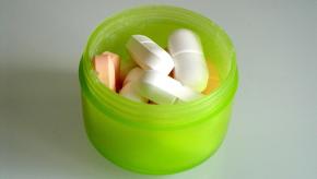 green container of pills