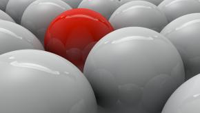 several white balls with one red ball in the middle