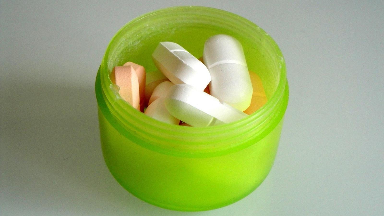 green container of pills