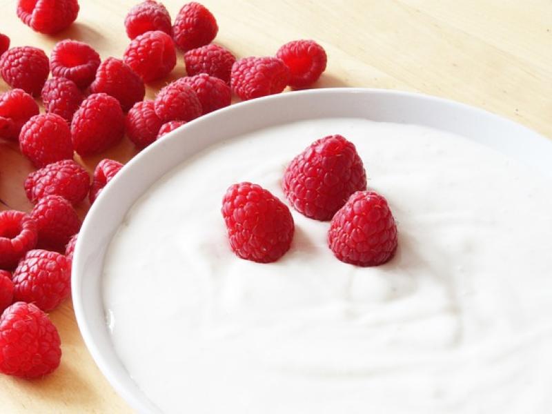 a bowl of yogurt with raspberries